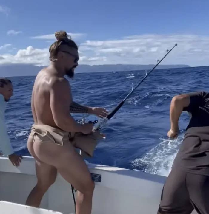 Jason fishing with others while wearing a malo
