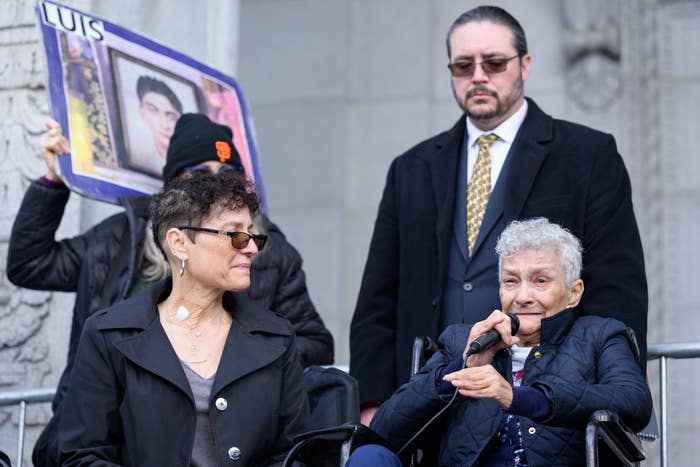 two women sit giving a speech at a protest for justice for Keita O&#x27;Neil