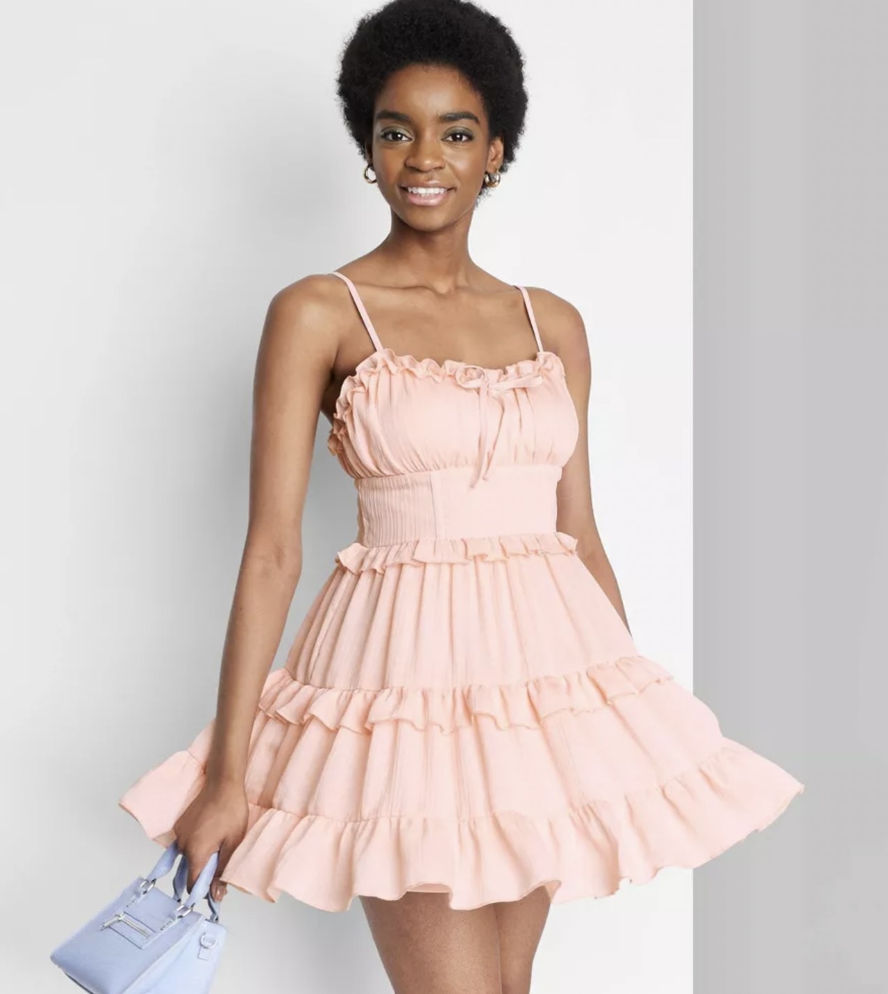 a model wearing the dress in pink