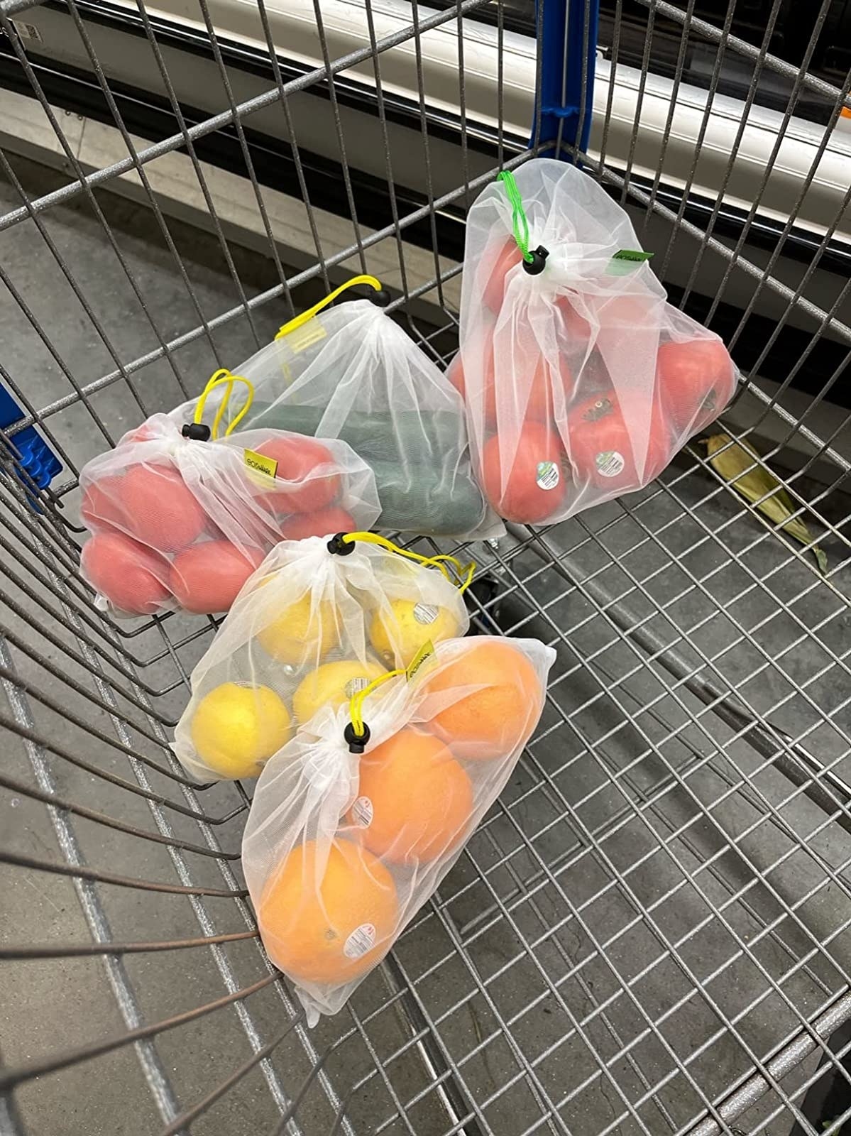 Reviewer image of the reusable bags holding produce in their shopping cart