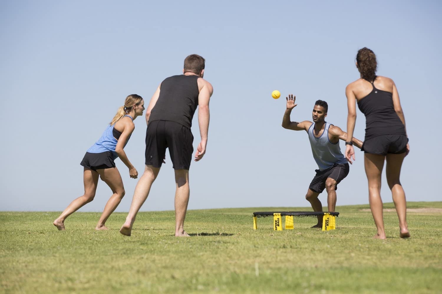 a group of people playing spikeball