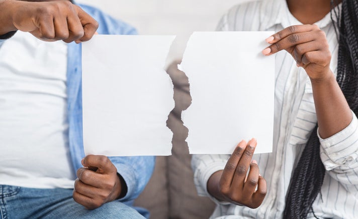 couple holding torn paper