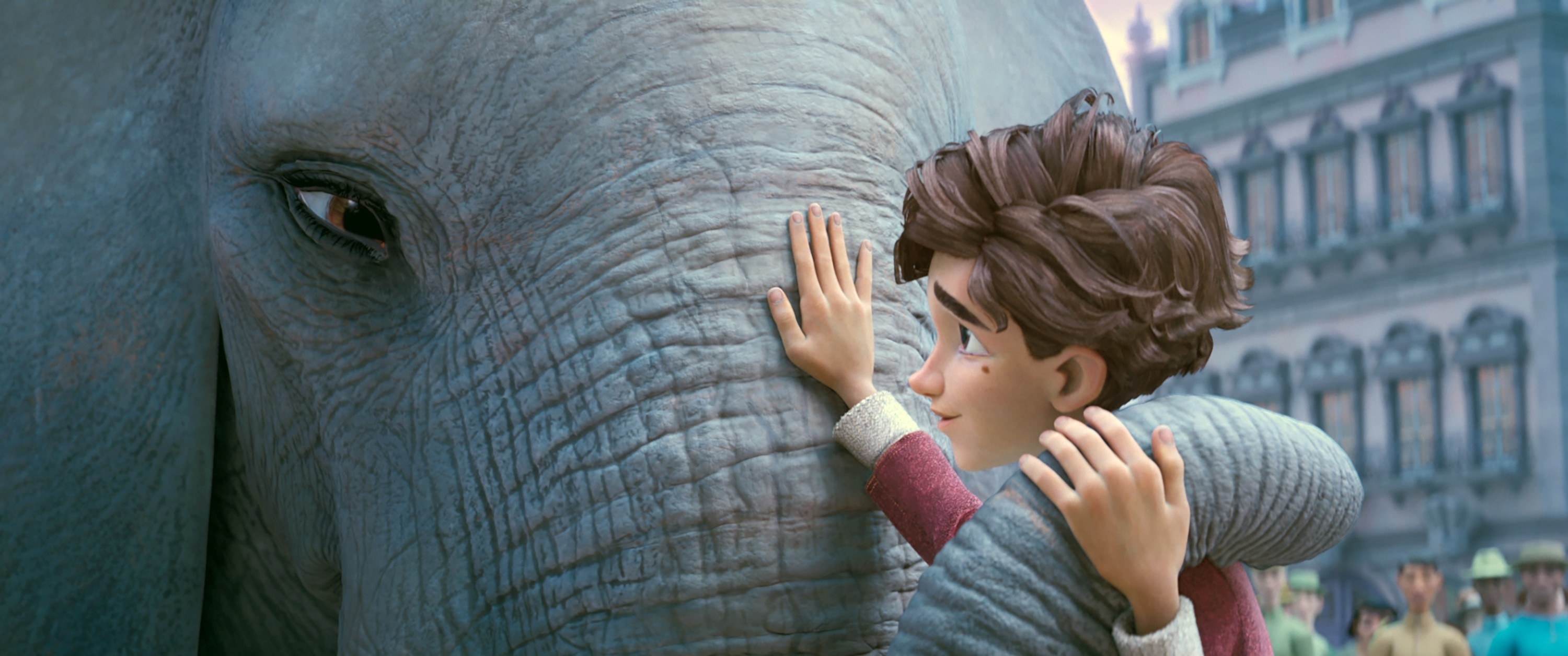 A young boy pets an elephant