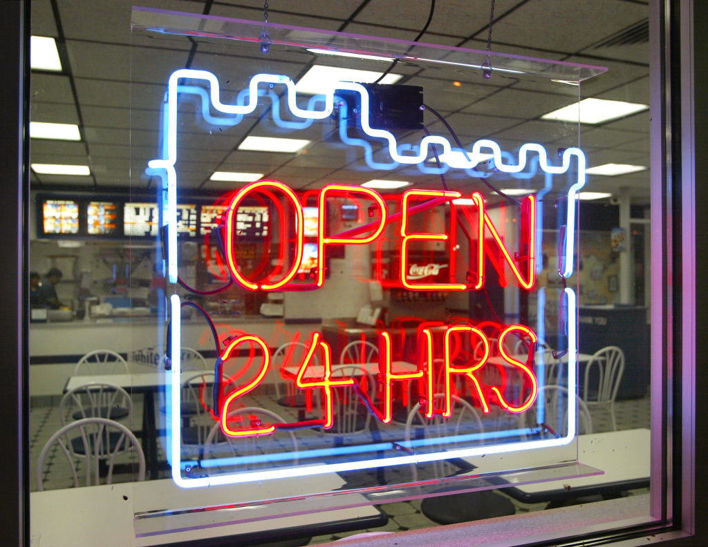 A sign saying the restaurant is open 24 hours