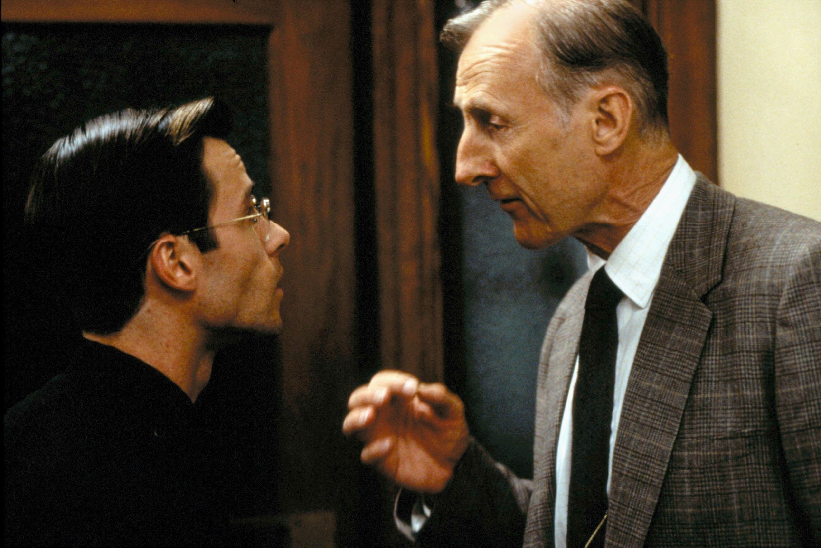 James Cromwell in a suit talks succinctly to Guy Pearce