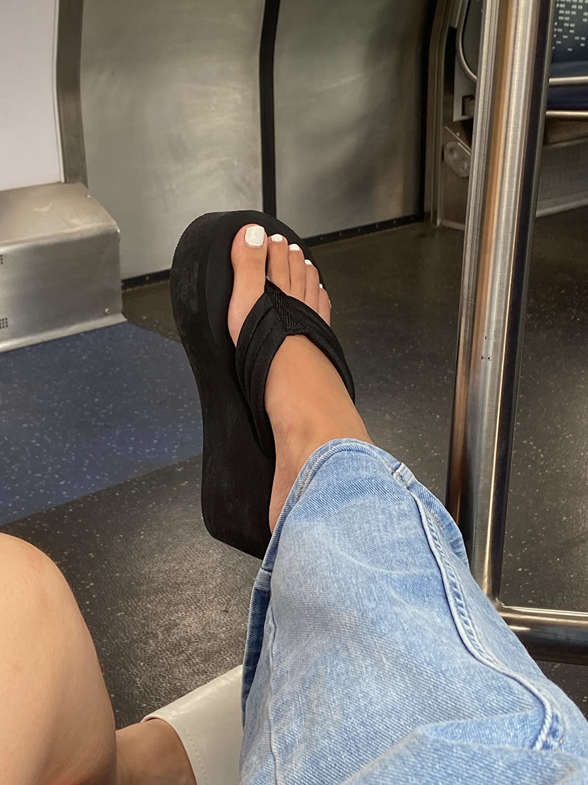 Reviewer wearing black platform flip flop with jeans