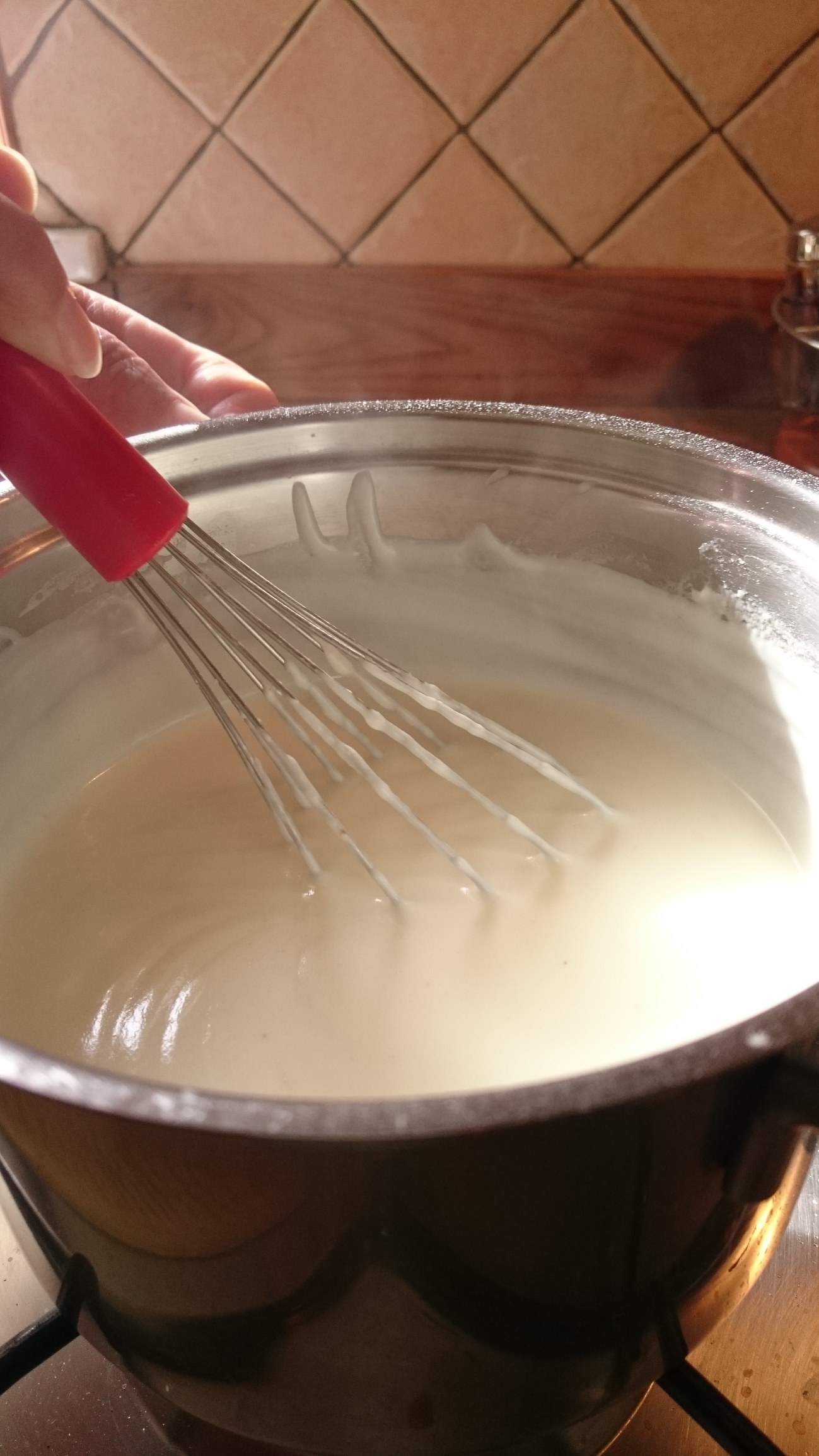 Stirring a pot of cream sauce