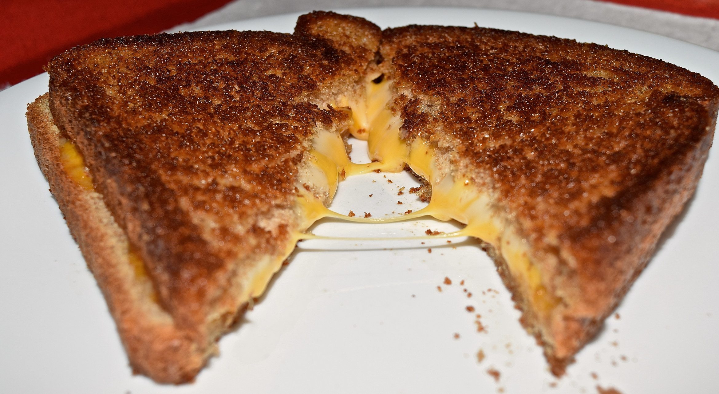 A grilled cheese sandwich cut into triangles