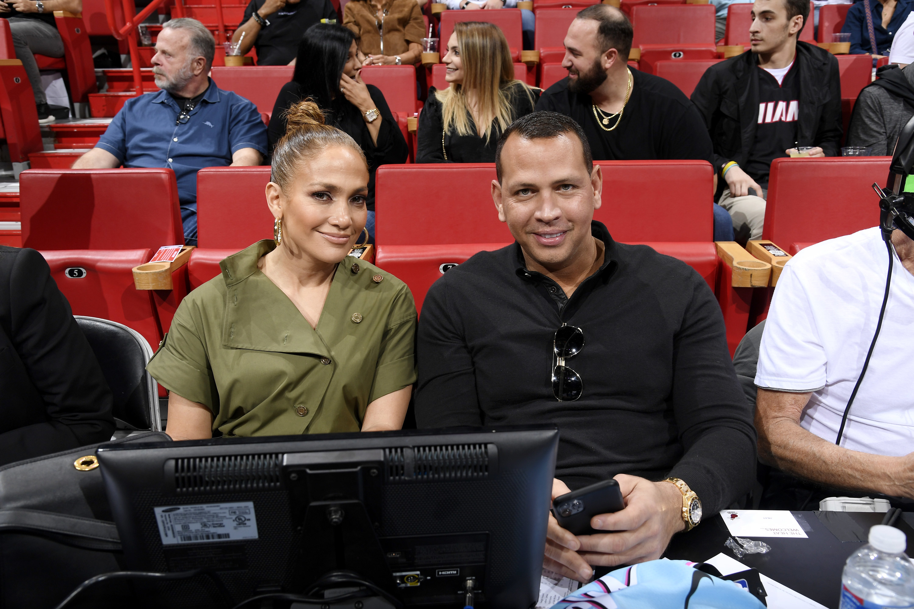 The former couple sitting together at a basketball game