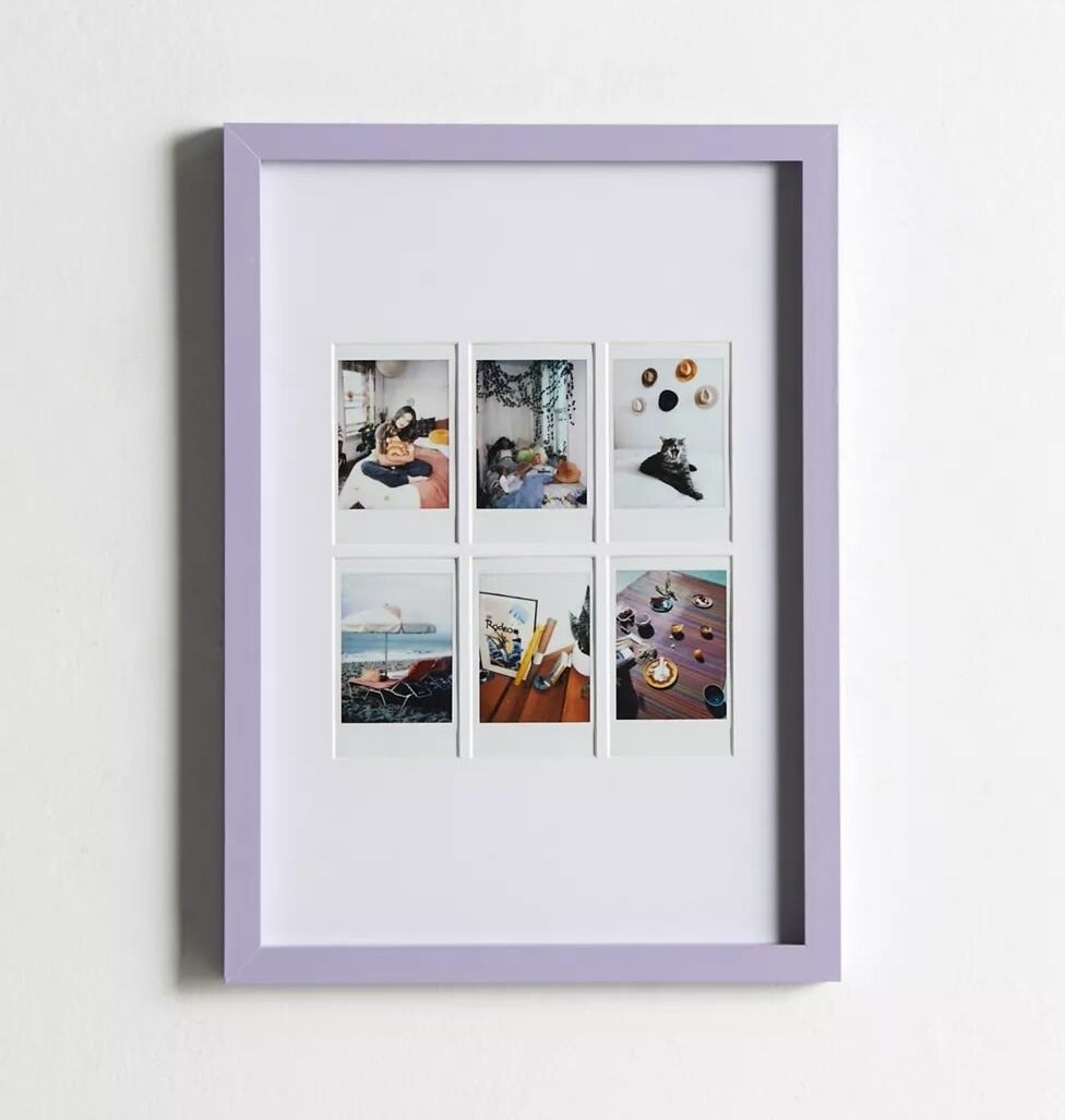 a photo frame with six instant photos in it