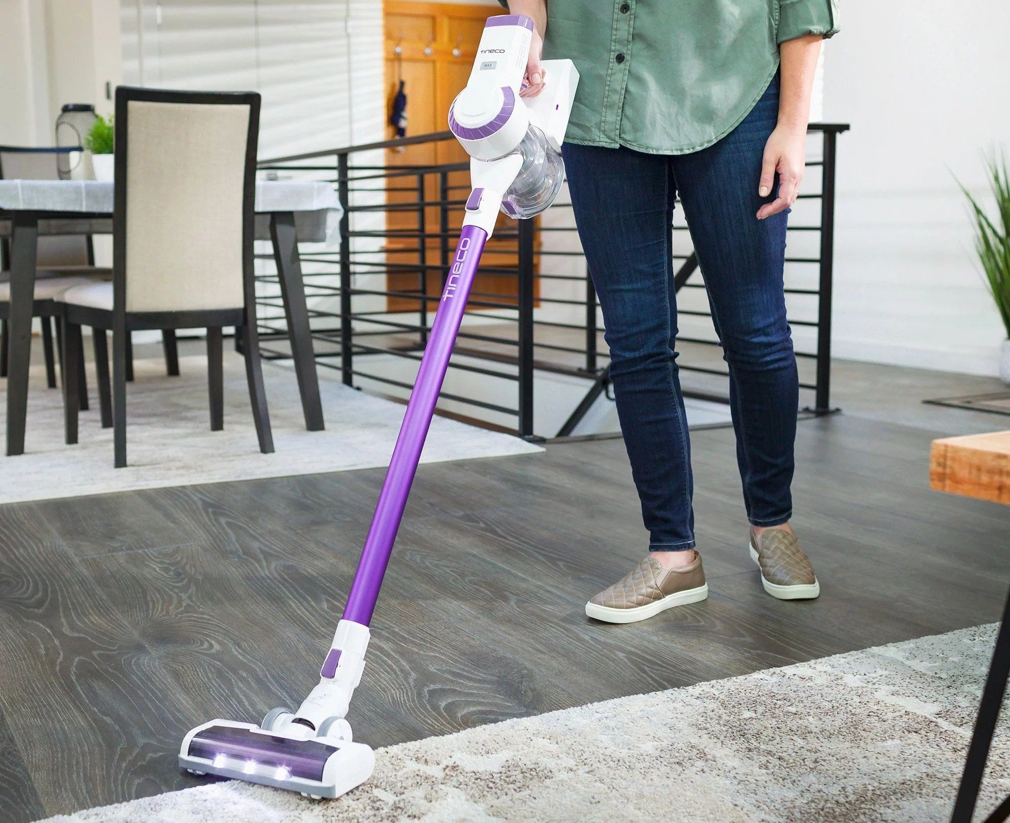 a person using the stick vacuum