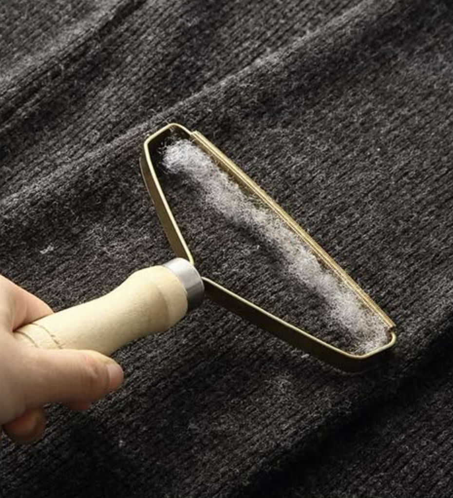 a person using the shaver on a wool sweater