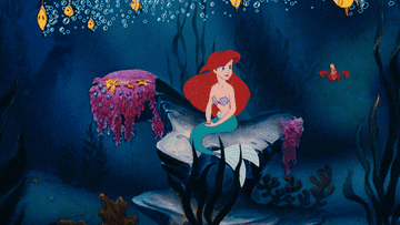 GIF of the animated version of the Little Mermaid swimming with Sebastian and fishes