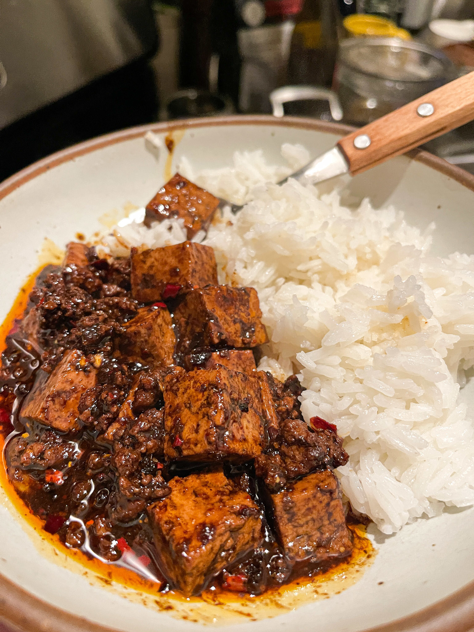 Tofu and beef in a fiery red sauce next to steamed white rice