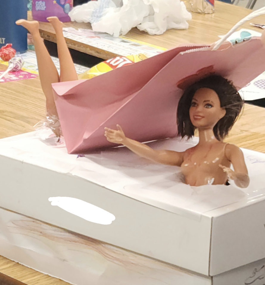 A barbie sticking out of a box