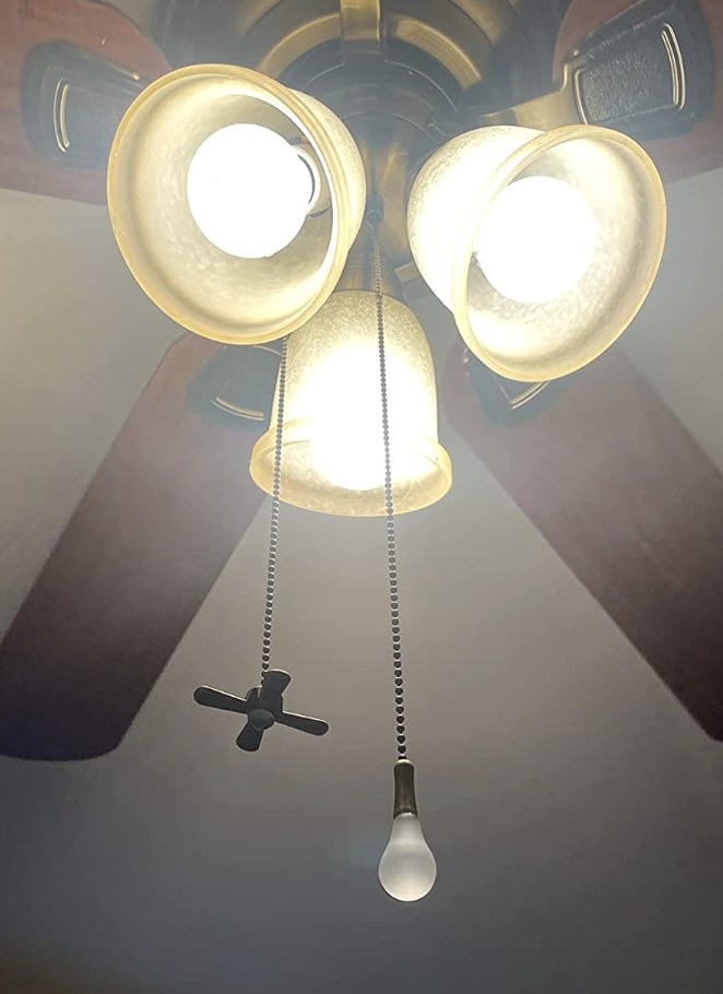 A picture of a ceiling fan with the pulls installed