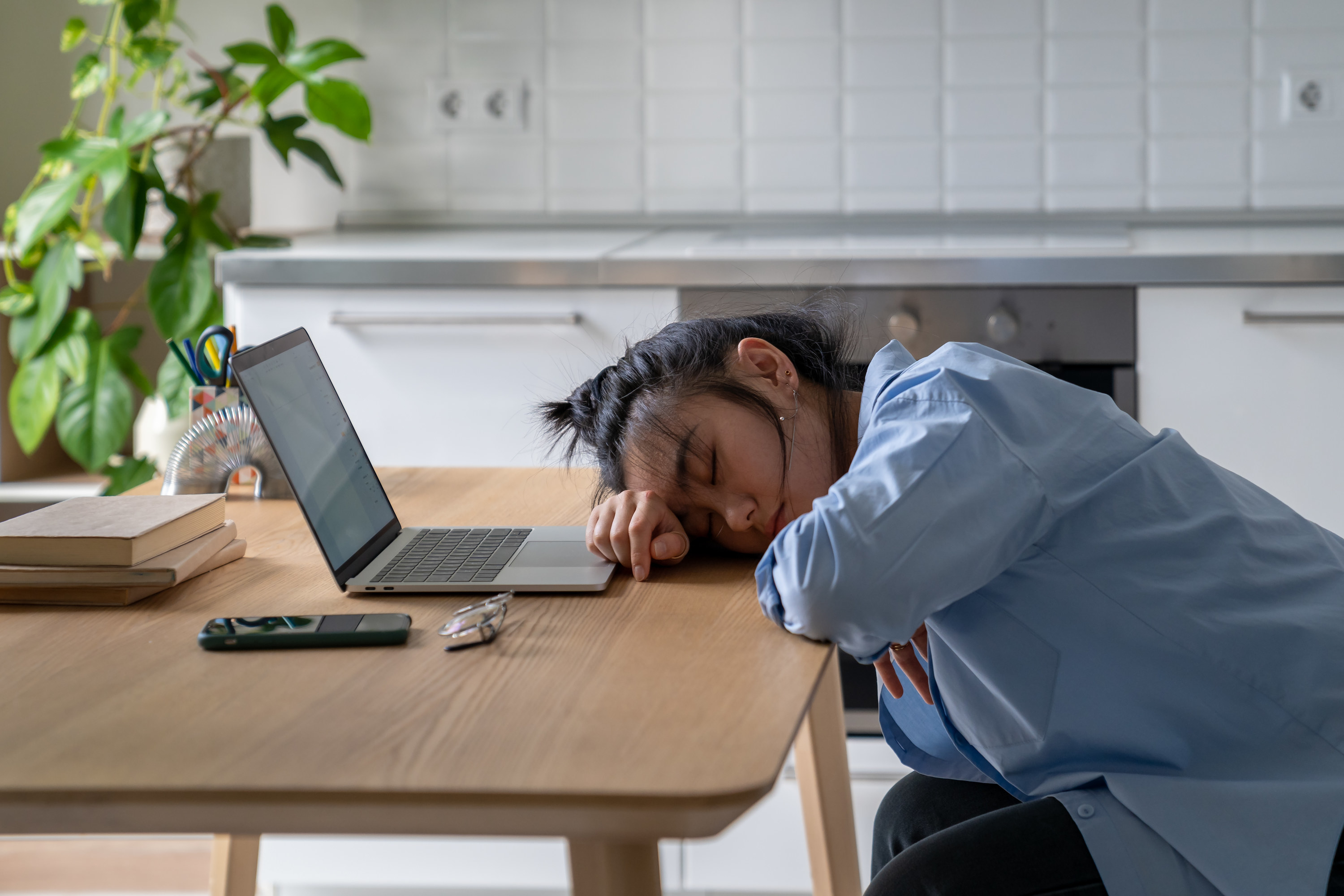 exhausted person sleeping at their desk