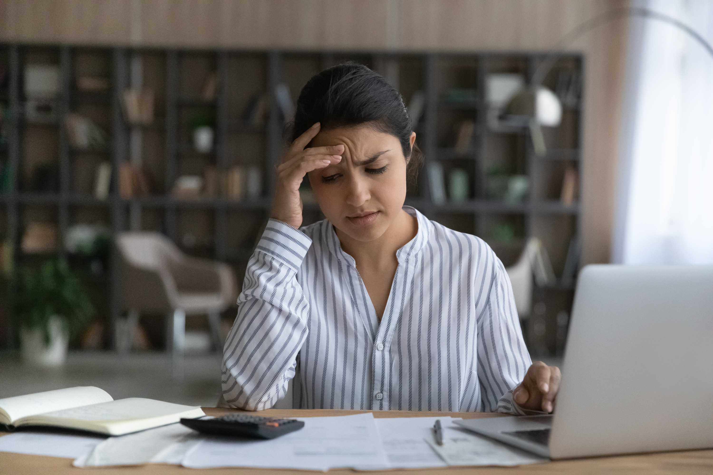 young person stressed out while trying to figure out household finances