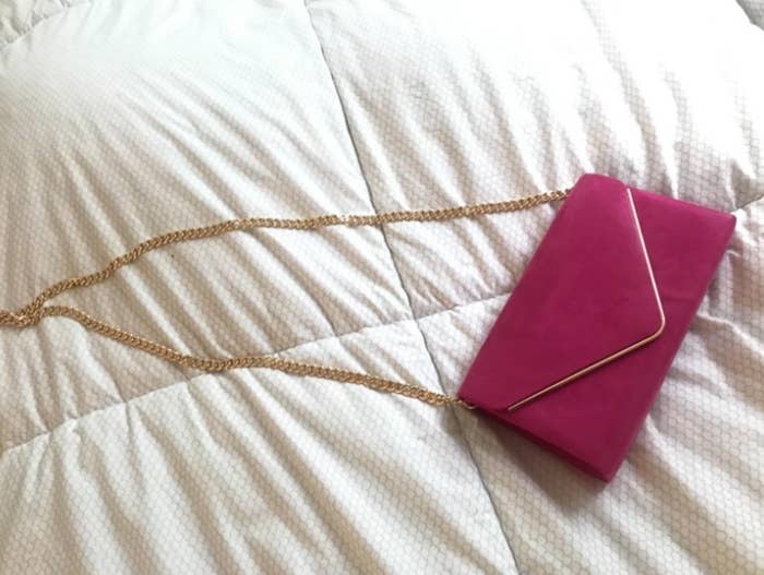 a reviewer&#x27;s photo of the clutch purse in pink