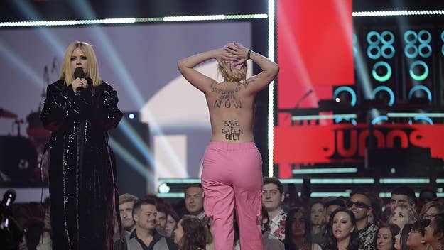 After running up on the stage in the middle of the Juno Awards, the topless woman spent a night in jail and then appeared in an Edmonton courtroom on Wednesday.