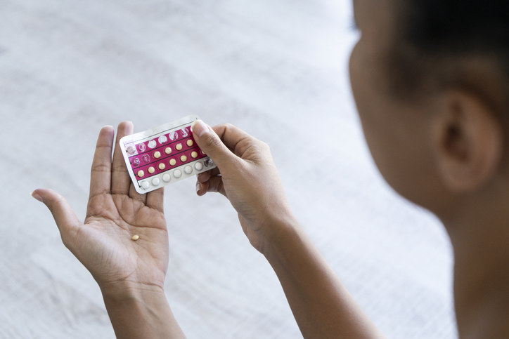 Woman holding a pack of birth control pills