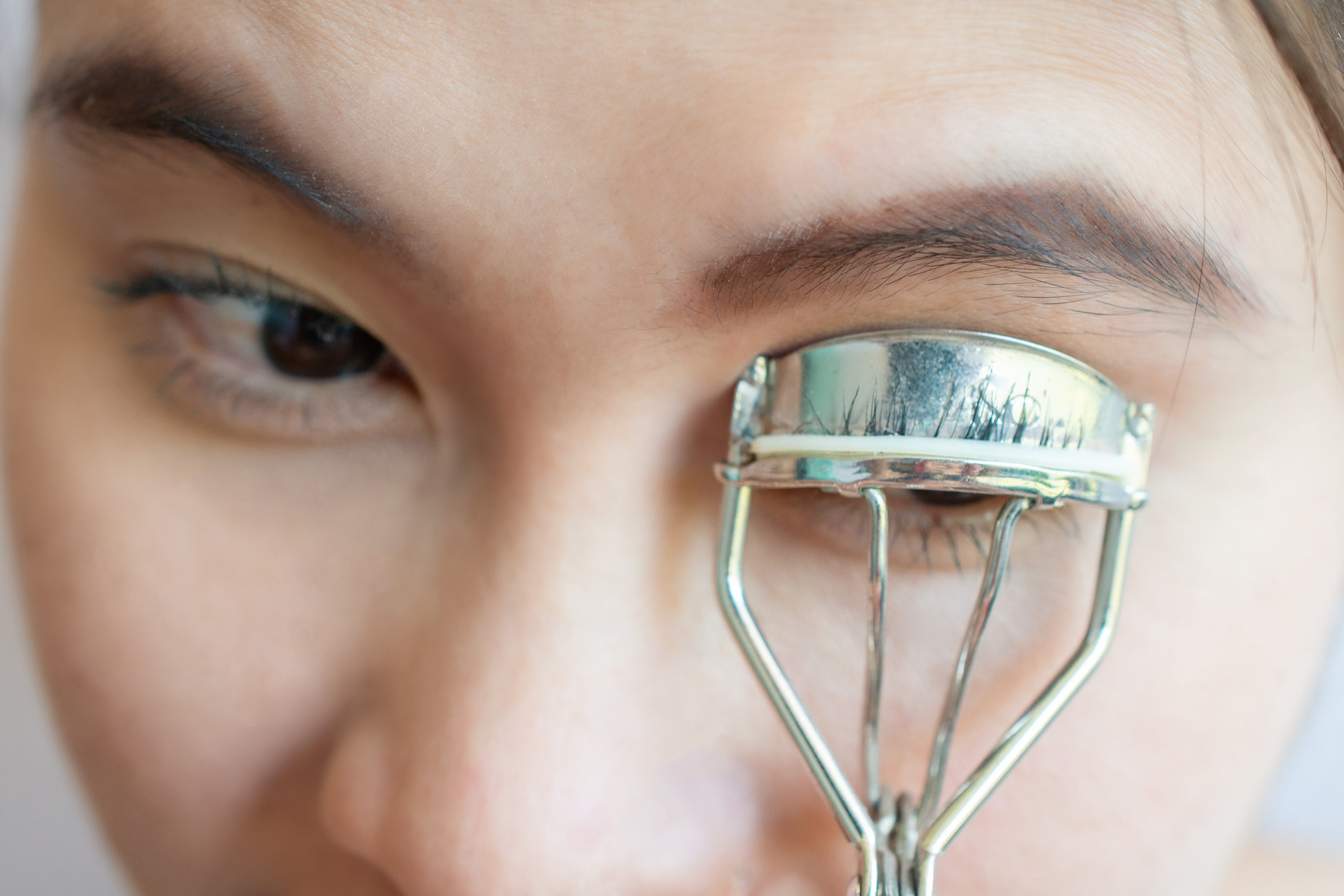 Woman using an eyelash curler