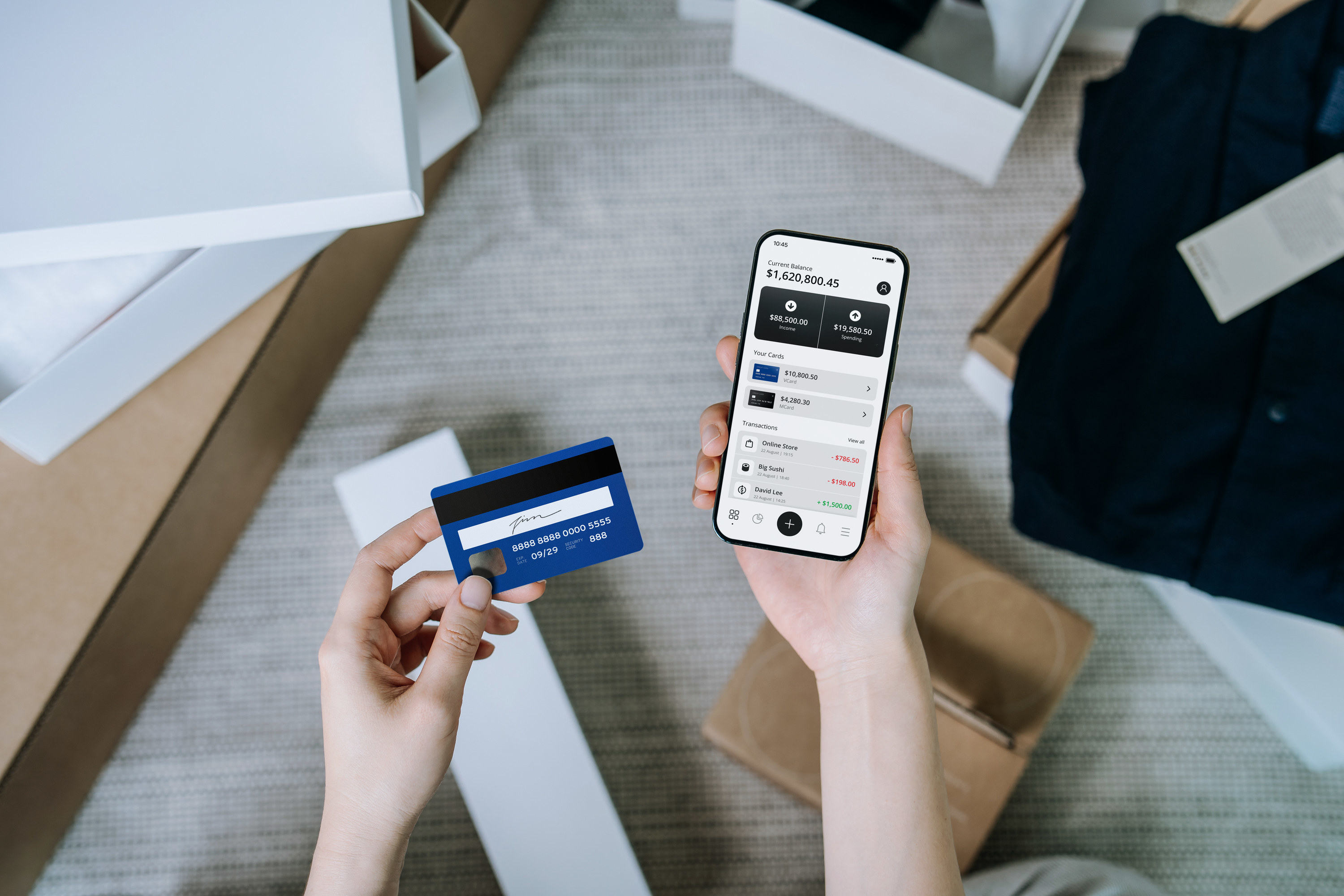 woman holding her phone and a credit card