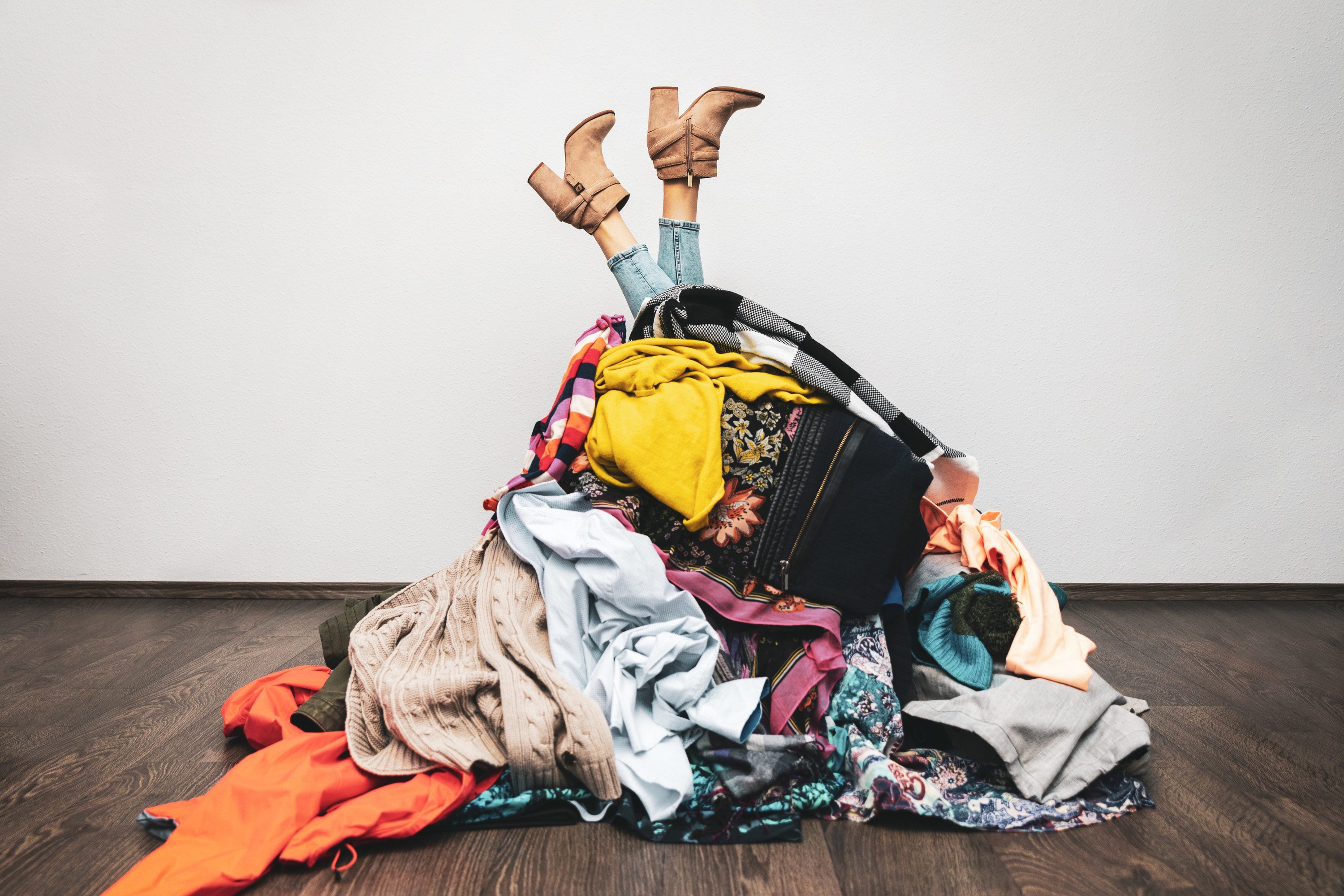 woman buried in a pile of clothes