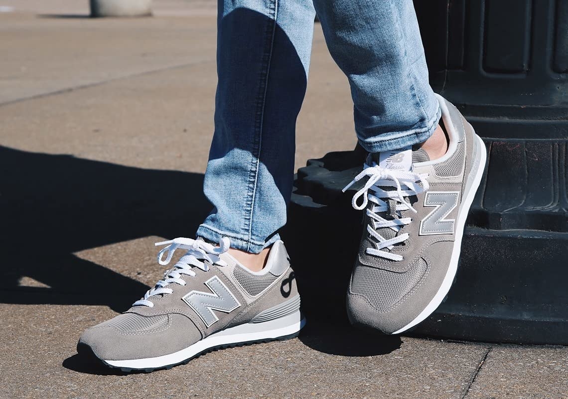 reviewer wearing the sneakers in a gray and white colorway
