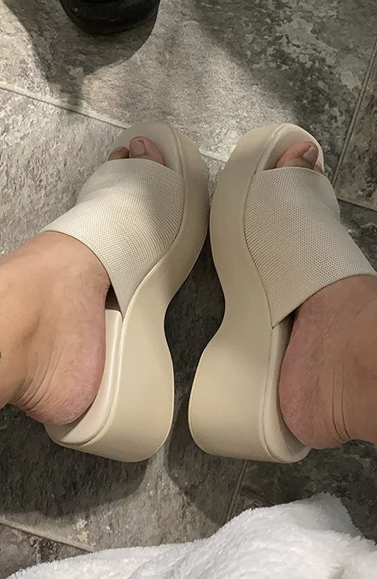 reviewer wearing the sandals in beige