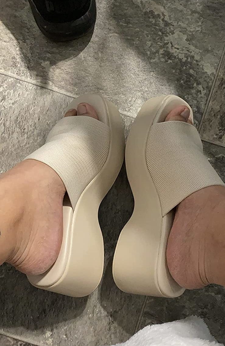reviewer wearing the sandals in beige