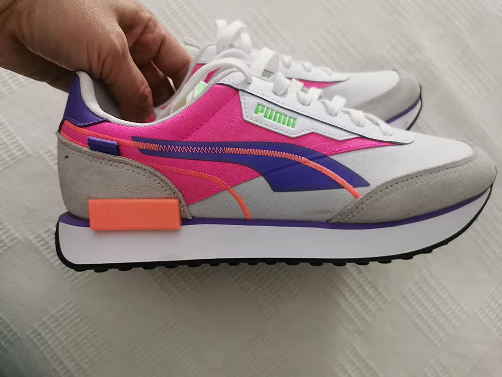 the sneakers in the white pink luminous colorway