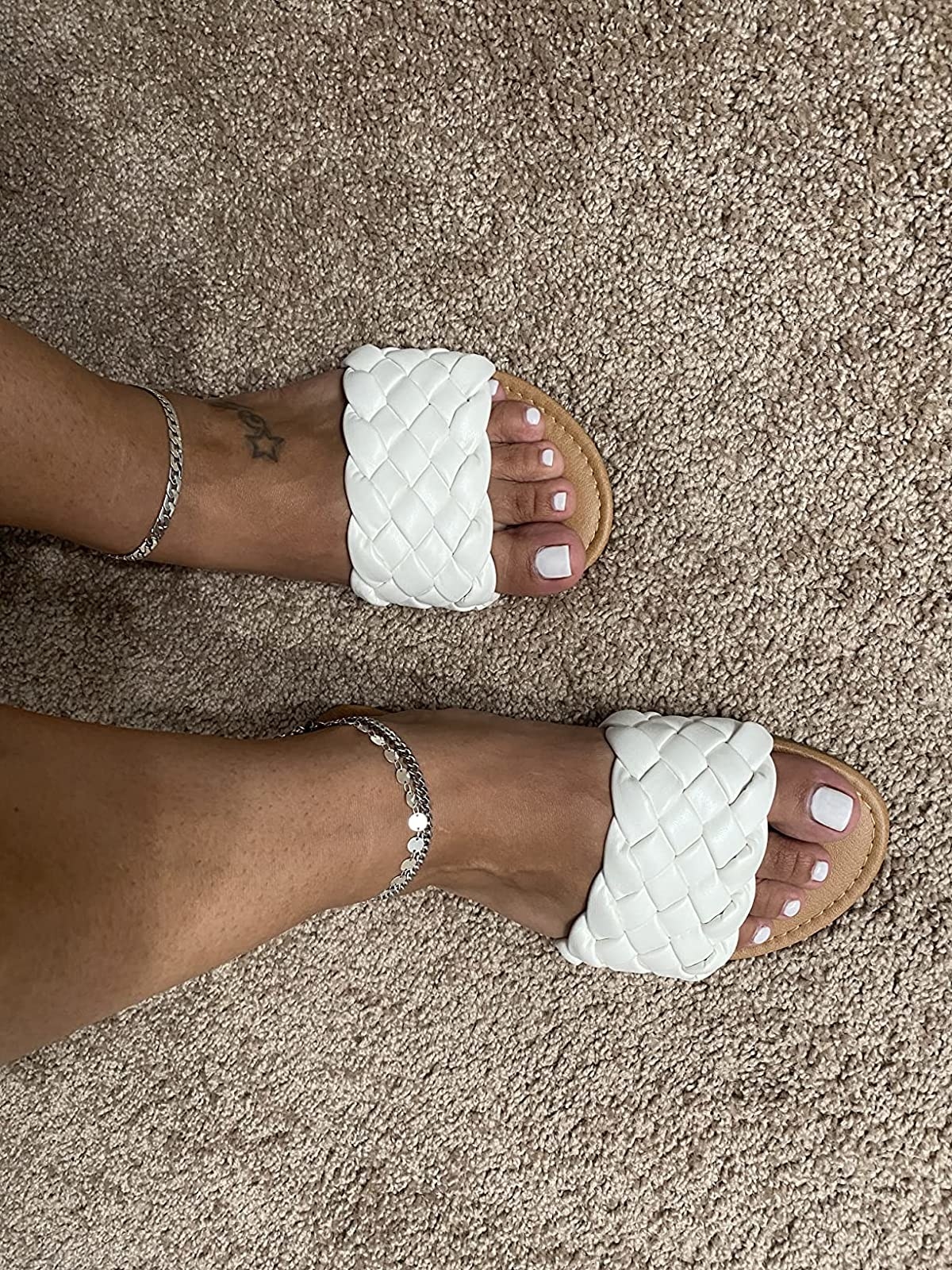 reviewer wearing the braided sandals in white