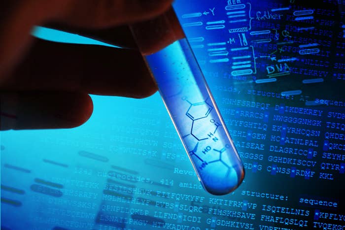 A hand holding a tube of DNA