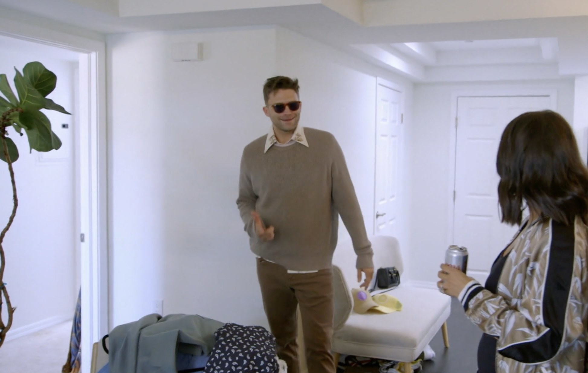 Schwartz trying on clothes in his new apartment with Scheana