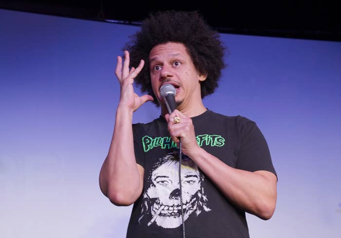 Eric holding a microphone onstage