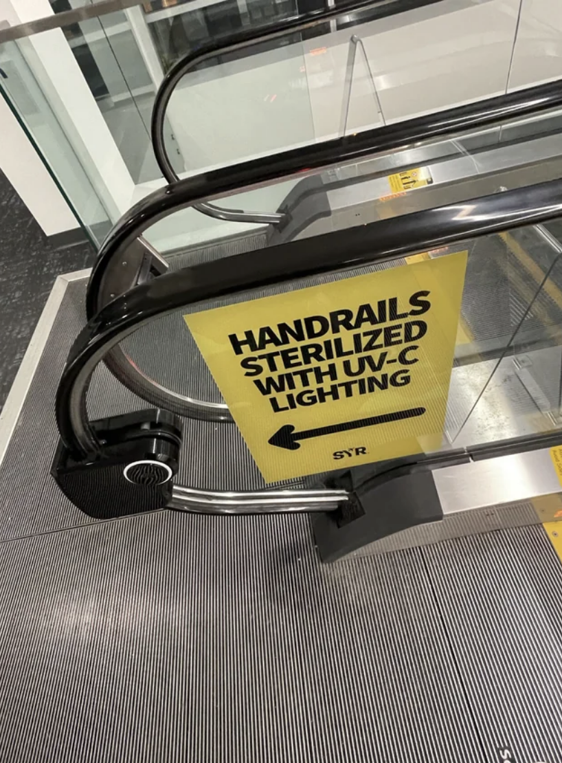 A machine that sanitizes the hand rails of an escalator