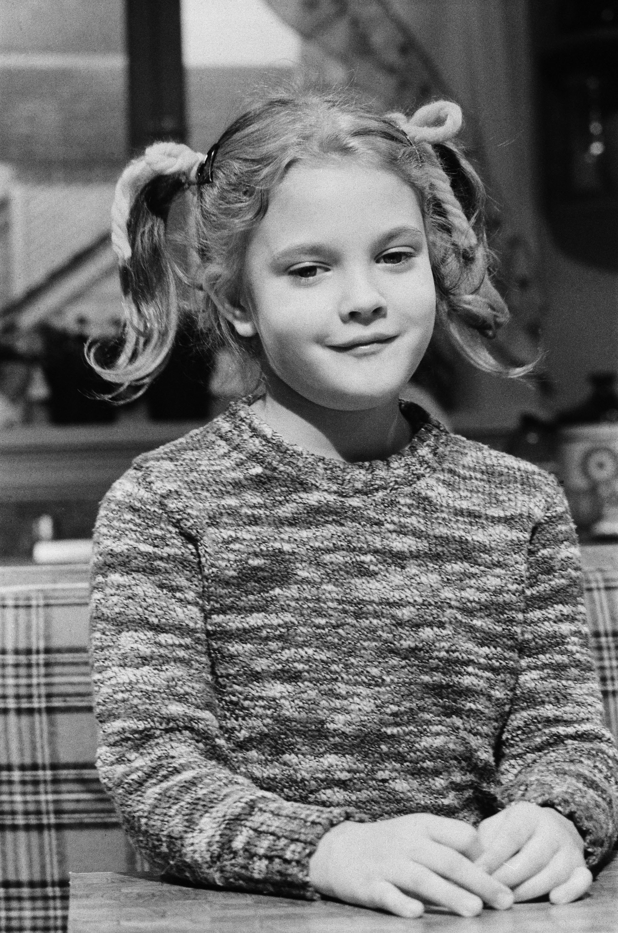 A black and white photo of Drew as a kid, her hair in pigtails