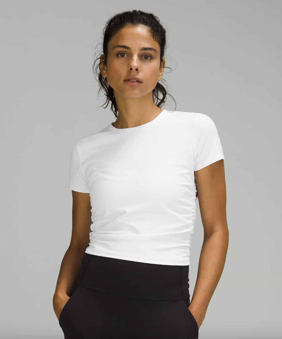 a person wearing the side cinched tee shirt with trousers