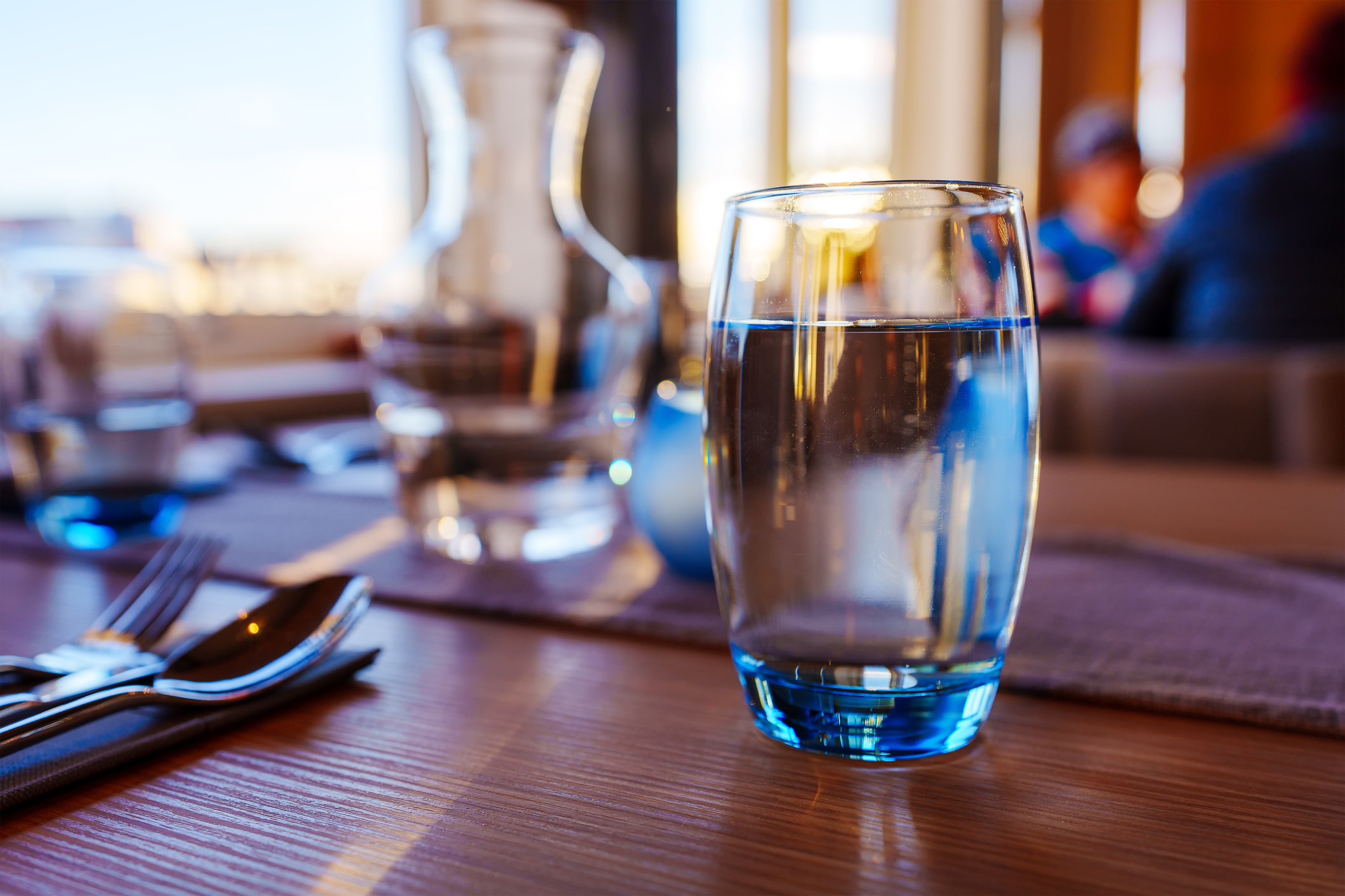 A glass of water on a table.