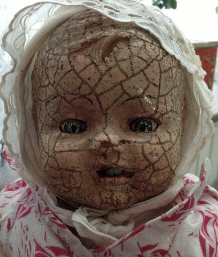 closeup of a porcelain doll with a cracked face