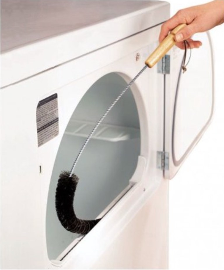 a model holding the flexible brush in the lint trap area of a white clothes dryer