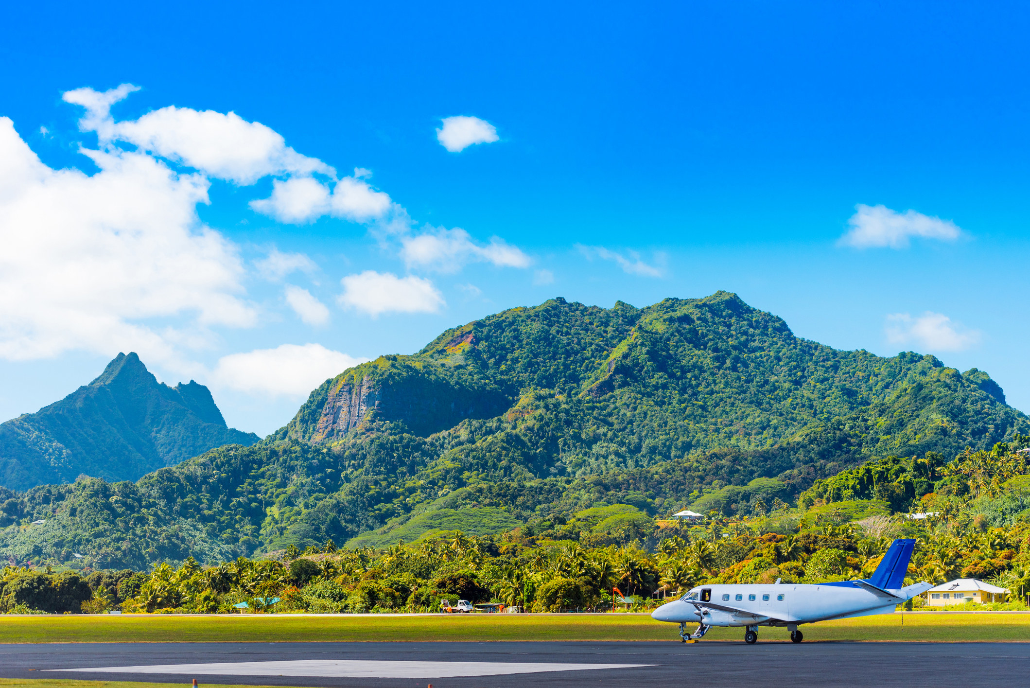 An airplane with mountains in the backgtound.