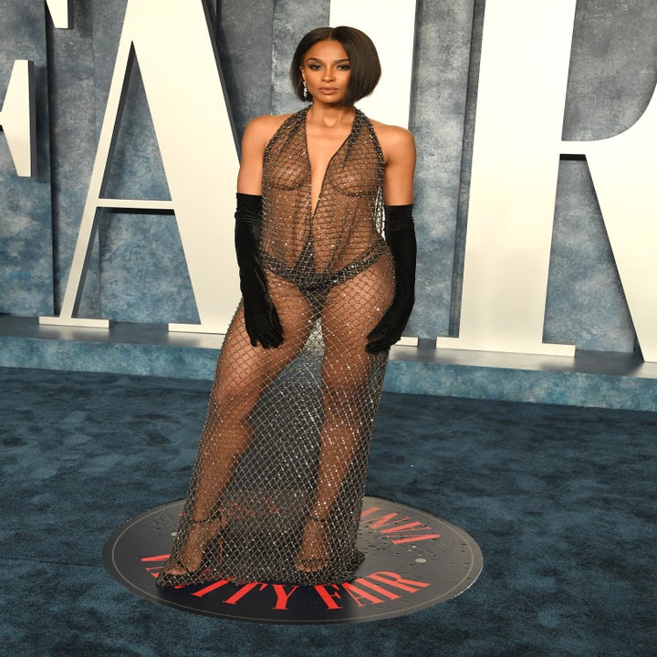 Ciara poses for photographers in her see-through dress on the blue carpet
