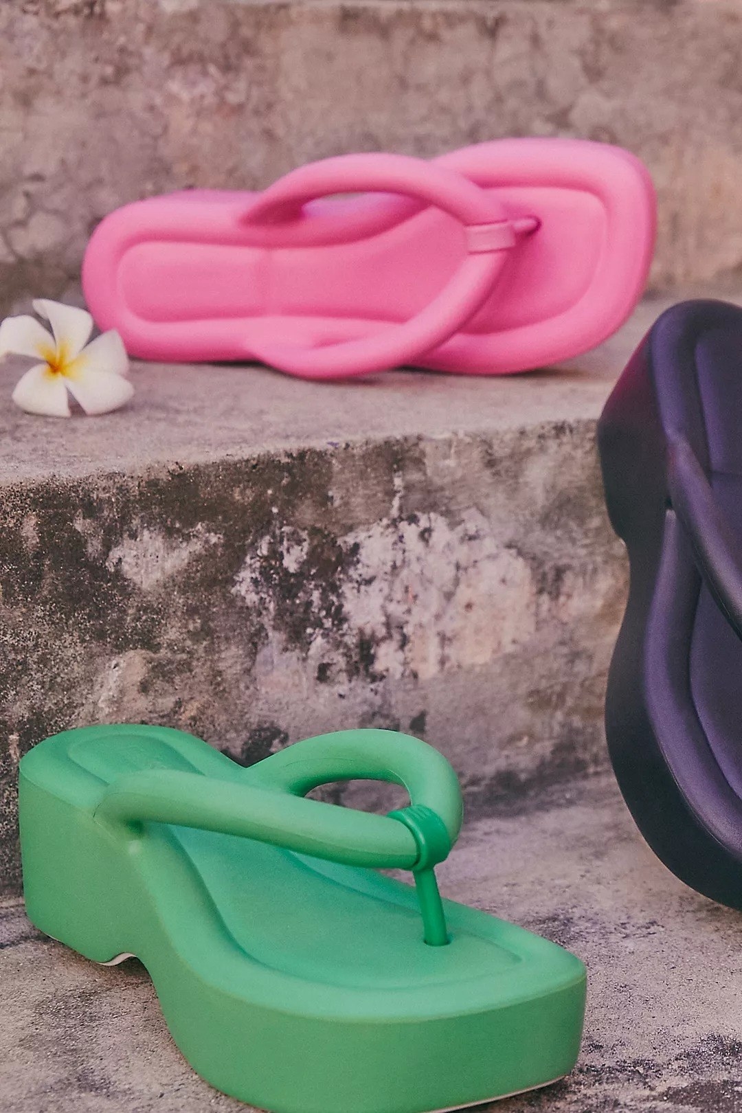 the sandals in green, pink, and black