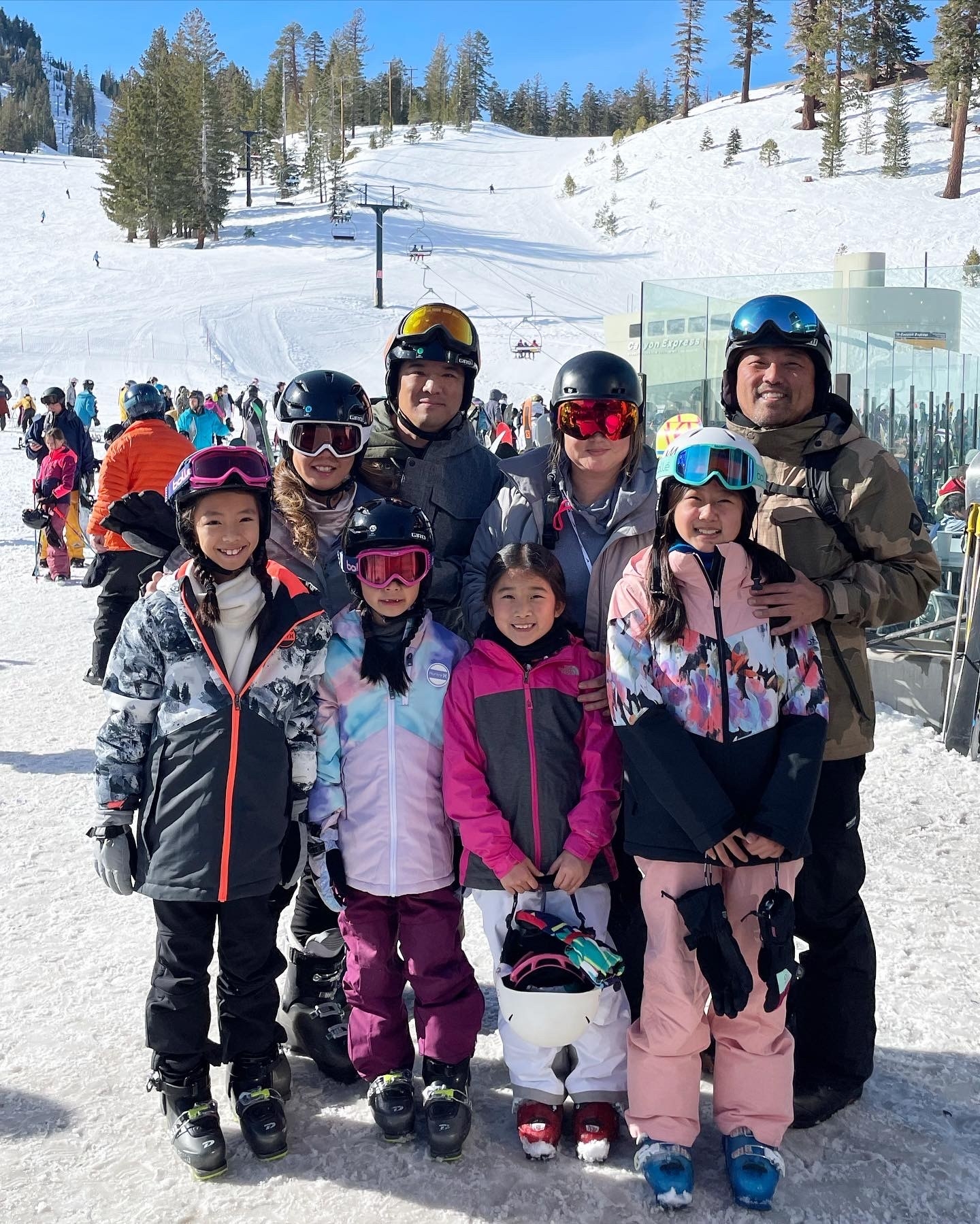 Family in ski gear on hill