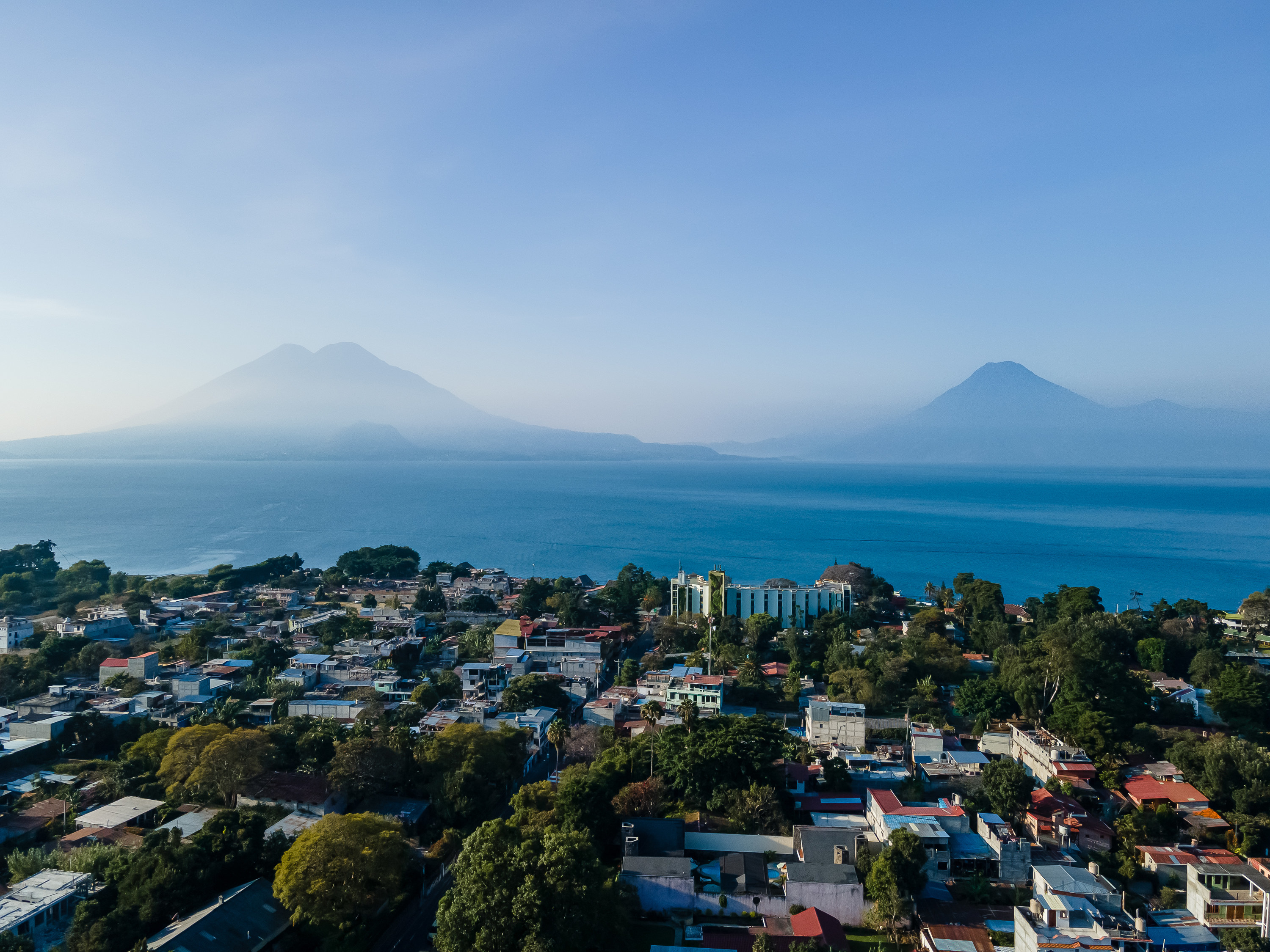 Aerial view of two large volcanos with houses below