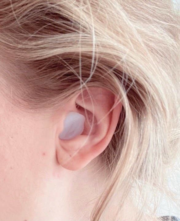 buzzfeed writer with a form-fitting silicone earplug in their ear
