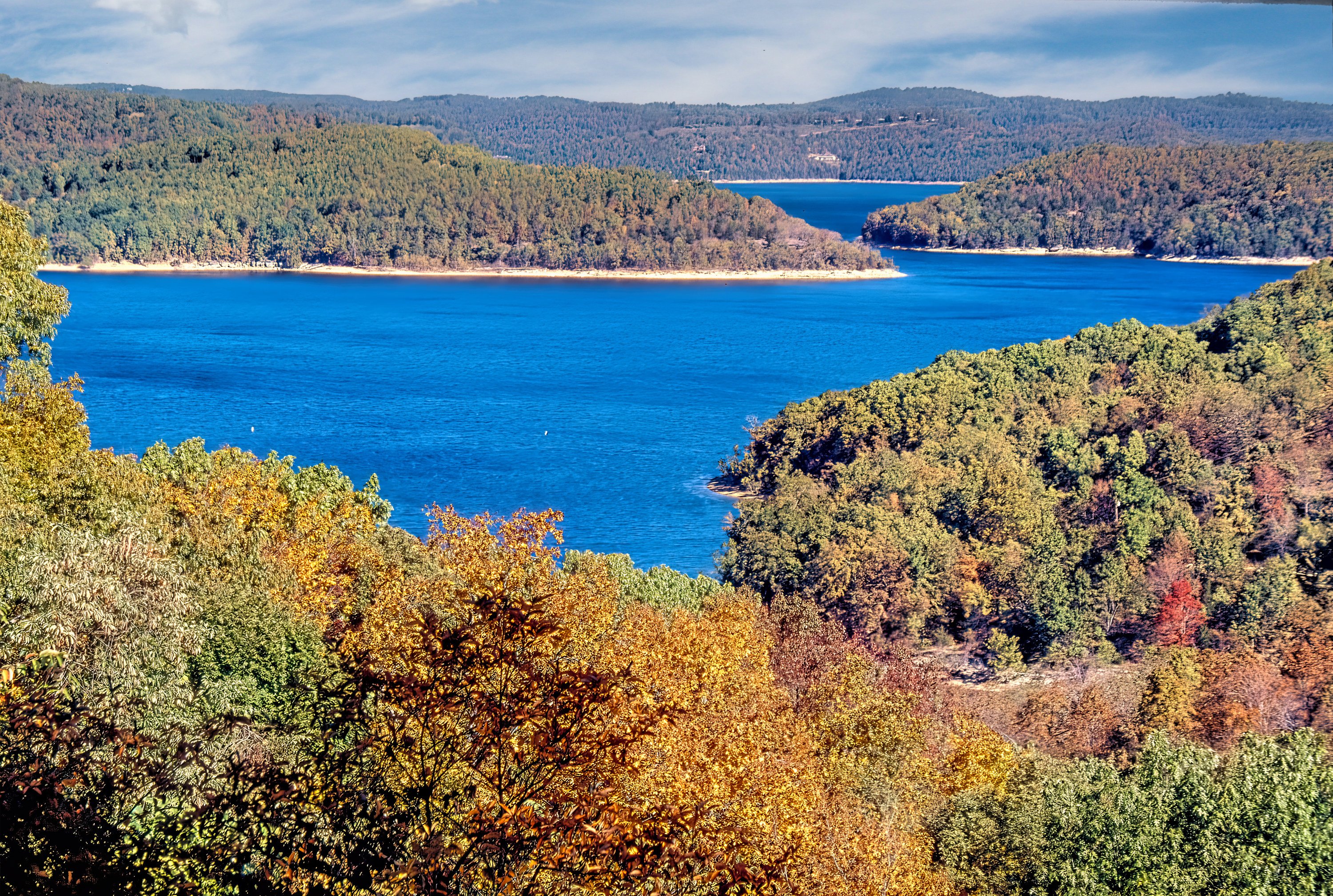 Lake with small islands in the middle, fall foliage on trees