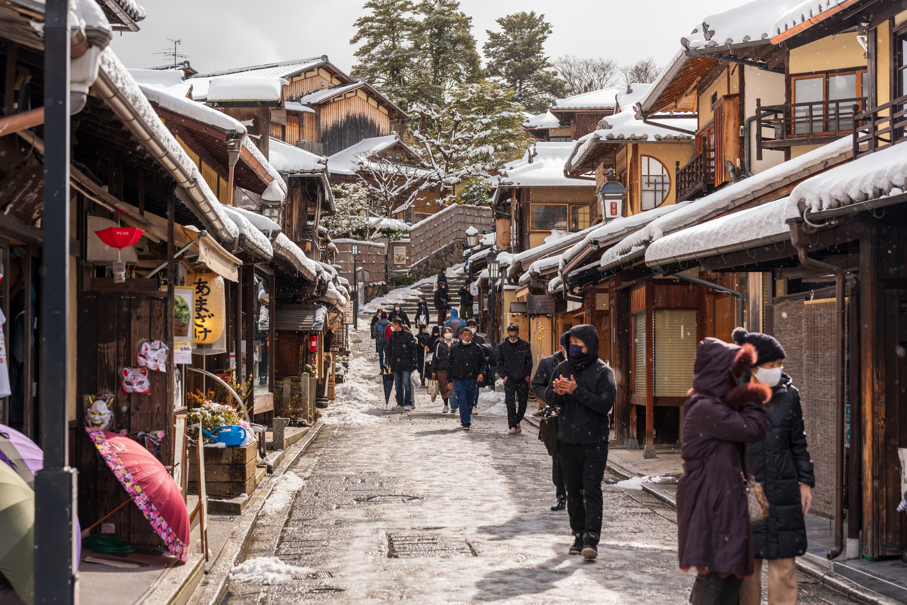 Snowy winter street with people walking
